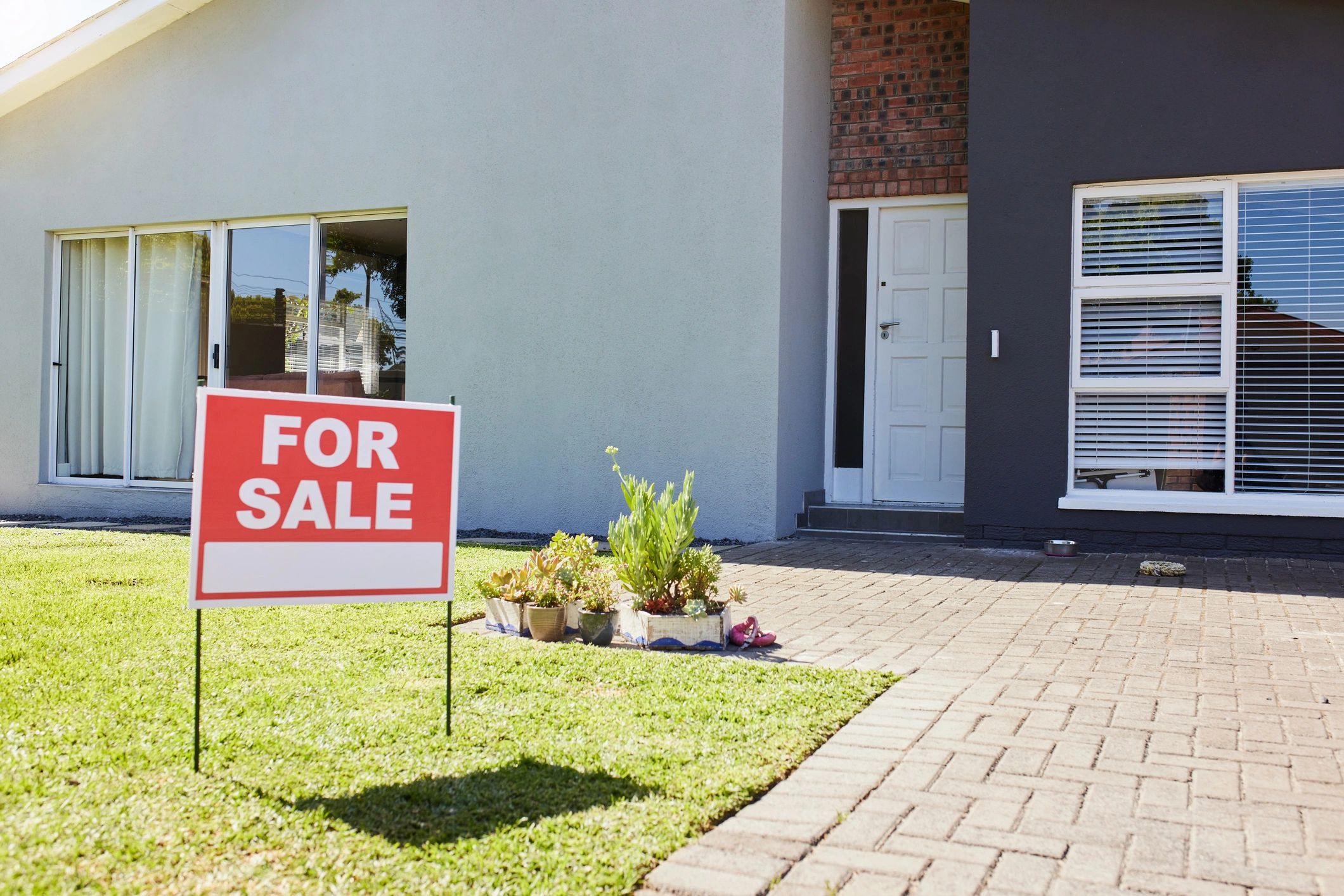 for sale sign in front of house